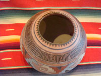 Mexican vintage pottery and ceramics, a fabulous globe-shaped pottery jar with an Aztec design, c. 1930's. A photo showing the top and inside of the jar.