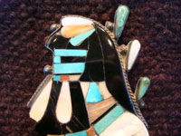Native American Indian vintage silver jewelry, a Zuni broach with inlay, c. 1940. Closeup photo of the head of the Naja.