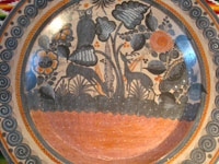 Mexican vintage pottery and ceramics, a beautiful burnished charger from Tonala, c. 1940. The burnished pottery charger features a lovely owl and two graceful deer amidst plants and foliage. Closeup of the front of the charger.