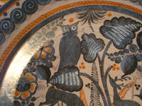 Mexican vintage pottery and ceramics, a beautiful burnished charger from Tonala, c. 1940. The burnished pottery charger features a lovely owl and two graceful deer amidst plants and foliage. Closeup of the owl on the front of the charger.