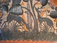 Mexican vintage pottery and ceramics, a beautiful burnished charger from Tonala, c. 1940. The burnished pottery charger features a lovely owl and two graceful deer amidst plants and foliage. Closeup of the deer on the front of the charger.