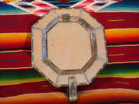 Mexican vintage tin-art (tinwork art), an octagonal tinwork mirror with a single candleholder at the base, c. 1930-40. Photo of the back side of the mirror.