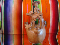Mexican vintage folk art, and Mexican vintage pottery and ceramics, a candlelabra in the form of a lovely woman riding atop her steer, attributed to the great Heron Matinez during his burnished natural period, Acatlan, Puebla, c. 1950's. Main photo of the Heron Martinez piece.