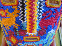 Mexican vintage folk art, and Mexican vintage woodcarvings and masks, a beautifully beaded wood-carved Huichol mask, Jalisco, c. 1980.  Closeup photo of a part of the beaded Huichol mask.