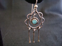 Closeup photo of Native American Indian silver jewelry, Navajo earrings with turquoise.