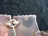 Closeup photo of Mexican vintage silver jewelry showing the stamped signaturel.