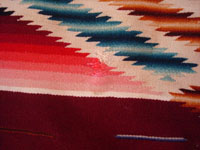 Mexican vintage textiles, a Saltillo sarape, c. 1940. Beautiful burgundy background. Made of very finely woven wool with silk in the center medallion and decorative side-bars.  Another closeup photo.