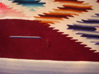 Mexican vintage textiles, a Saltillo sarape, c. 1940. Beautiful burgundy background. Made of very finely woven wool with silk in the center medallion and decorative side-bars.  Another closeup photo.