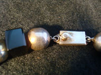 Mexican vintage silver jewelry and Taxco silver jewelry, a wonderful necklace composed of silver balls and square pieces of black jet, signed with the mark and number of Jose Marmolejo, Taxco, c. 1960-70's. A closeup of the clasp.