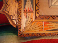 Mexican vintage "straw-art" (popote art or popotillo) tray, c. 1940's. The popote art is very fine and very intricate. The frame is also decorated with very fine popote or straw-art, and incised geomtric patterns in the wood on the handles of the frame and and in the wood immediately around the central image. A closeup photo showing a corner of the frame.