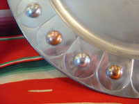 Mexican vintage tin-art or tinwork art, a large tin tray with copper, c. 1950. The tray itself is surrounded by punched-out bolitas or balls, with alternating tin and copper composition. Closeup photo of tray.