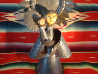 Mexican vintage tin-art (tinwork-art) and Mexican vintage devotional and folk art, a tin-art Virgin with Child, c. 1960. The stamping on the tinwork is wonderful, and the faces of the Virgin and Child are ceramic and are beautifully painted. Another photo of the front of the Virgin and Child.