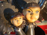 Mexican vintage tin-art (tinwork-art) and Mexican vintage devotional and folk art, a tin-art Virgin with Child, c. 1960. The stamping on the tinwork is wonderful, and the faces of the Virgin and Child are ceramic and are beautifully painted. Another closeup photo of the faces.