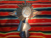 Mexican vintage tin-art (tinwork-art) and Mexican vintage devotional and folk art, a tin-art Virgin with Child, c. 1960. The stamping on the tinwork is wonderful, and the faces of the Virgin and Child are ceramic and are beautifully painted. Photo of the back of the statue.