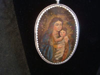 Mexican vintage devotional art, and Mexican vintage sterling silver jewelry, a beautiful relicario with the small retablo beautifully painted on tin, with a lovely hand-made sterling silver chain, c. 1920's.  Closeup photo of the second side of the relicario.