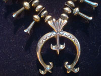 Native Amaerican vintage sterling silver jewelry, and Navajo vintage sterling silver jewelry, a beautiful squash blossom necklace, all silver with stamping on blossoms and Naja, Arizona or New Mexico, c. 1950's. Another closeup photo of the naja on the front of the necklace.