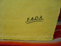 Mexican vintage pottery and ceramics, and Mexican vintage folk art, a pottery apartment building with happy tenants, Santa Cruz de las Huertas, Jalisco, c. 1970-80's. Signed YADR, for Jose Juan Ramos Medrano, the grandson of famed potter Candelario Medrano. A photo showing the artist's signature on the bottom of the piece.