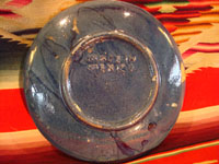 Mexican vintage pottery and ceramics, and Mexican vintage folk art, a pottery plate from Tlaquepaque, Jalisco, with a wonderful scene of a fox and beautiful bird (a quetzal), on a dark blue slip, c. 1930-40. Photo showing the bottom or backside of the plate.