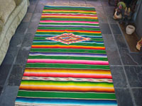 Mexican vintage textiles and sarapes, a beautiful Saltillo sarape with a green background, c. 1940's. Very fine wool with silk in the center medallion and decorative side bars. Main photo.