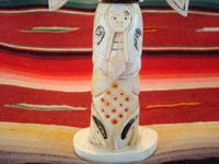 Native American Indian antique folk art, a carved, bone totem pole from Alaska, c. 1920-30's. The figure of the Raven with outstretched wings (the mythical hero of the Tlingit) hovers at the top of the pole, sheltering the three children of the sun. Photo of the bottom third of the pole.