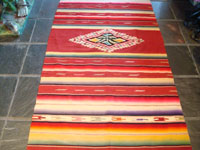 Mexican vintage sarapes and textiles, an incredible Saltillo sarape with a beautiful center medallion, c. 1930's. The predominant color of this multi-colored piece is a beautiful red. Another view of the sarape.