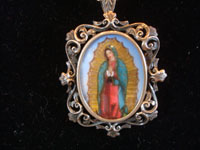 Mexican vintage devotional art, and Mexican vintage silver jewelry, a beautiful pendant/pin on a silver chain, with a lovely image of Our Lady of Guadalupe, painted on porceline, c. 1940. Main photo of the pendant/pin.