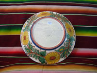 Mexican vintage pottery and ceramics, a lovely talavera bowl decorated with the image of the Baby Christ, along with his Mother, Mary, and St. Anne, the mother of Mary, Guanajuato, c. 1950's.  A photo showing the bottom of the bowl.
