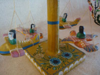 Mexican vintage folk art, and Mexican vintage woodcarvings and masks, a wonderful carved wooden merry-go--round with happy children riding in sparrows, laquerware, Olinala, c. 1950's. Photo showing the happy children riding in sparrows.