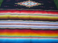 Mexican vintage textiles, and Mexican vintage Saltillo serapes (sarapes) and huipiles, a wonderful and very colorful Saltillo-style serape with a beautiful center medallion and embroidery between bands of color, c. 1940's.  Closeup photo of one end of the serape showing the unique embroidery.