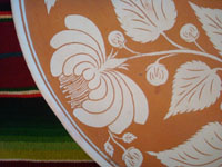 Mexican vintage pottery and ceramics, a large charger from Oaxaca with a wonderful floral pattern, c. 1940's. Another closeup photo of the floral decoration of the charger.