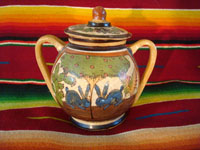 Mexican vintage pottery and ceramics, a lidded jar with handles from Tlaquepaque, Jalisco, c. 1930's. The lidded jar has the petatillo hatch-work pattern in the background, and features two wonderful blue bunnies amidst foliage on both the front and the back. Main photo.
