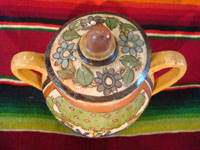 Mexican vintage pottery and ceramics, a lidded jar with handles from Tlaquepaque, Jalisco, c. 1930's. The lidded jar has the petatillo hatch-work pattern in the background, and features two wonderful blue bunnies amidst foliage on both the front and the back. Photo showing designs on the lid.