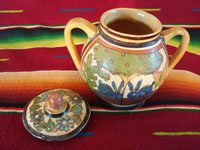 Mexican vintage pottery and ceramics, a lidded jar with handles from Tlaquepaque, Jalisco, c. 1930's. The lidded jar has the petatillo hatch-work pattern in the background, and features two wonderful blue bunnies amidst foliage on both the front and the back. Photo showing both the jar and the lid.