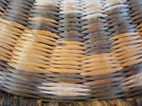 Native American Indian antique basket, a Hopi wicker plaque with eagle design, c. 1930. A closeup showing the fine stitches of the wicker plaque.