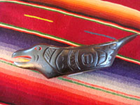 Native American Indian wood-carving and folk art, a Northwest Coast carved grease-bowl in the form of a raven, c. 1910-20. The raven bowl is beautifully carved and is wonderfully inlaid with pieces of abalone shell. Photo showing the side of the raven bowl.