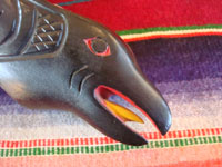 Native American Indian wood-carving and folk art, a Northwest Coast carved grease-bowl in the form of a raven, c. 1910-20. The raven bowl is beautifully carved and is wonderfully inlaid with pieces of abalone shell. Photo showing the beak and tongue of the raven.