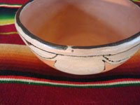 Native American Indian antique pottery, a chili bowl from Santa Ana Pueblo in New Mexico, c. 1910-20. The painted decorations on the bowl have faded with time, but are still incredibly beautiful. A side photo showing the spirit line of the bowl.