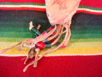 Native American Indian beadwork and folk art, a Plains knife-sheath with ghost-dance designs and symbolism, c. 1890-1910. The sheath is sinew sown with brain-tanned leather, and with fringe and bottom-tassles with beads. Photo showing the decorative tassles with beads at the bottom of the sheath.