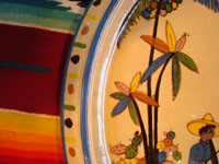 Mexican vintage pottery and ceramics, a large charger from Tlaquepaque, Jalisco, c. 1920-30. A closeup photo of one edge of the charger, showing the lovely palm trees.