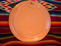 Mexican vintage pottery and ceramics, a wonderful charger from Tlaquepaque, c. 1930-40. Beautifully decorated with a Diego Rivera-like scene of a woman kneeling as she contemplates lovely flowers. Photo of the back of the charger.