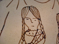 Mexican pottery and ceramics, a wonderful charger from Tzintzuntzan, Michoacan, on the shores of Lake Patzcuaro, c. 1990. Closeup photo of one of the womens' face.