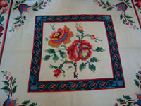 Mexican vintage sarapes and textiles, a lovely weaving from Oaxaca, c. 1910-20. The textile features lovely roses; it is an incredible piece of art. Closeup photo of the center of the textile.