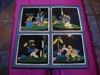 Mexican vintage pottery and ceramics, a wrought-iron table with four matching black-ware tiles, the tiles from Tlaquepaque, Jalisco, c. 1930's. Photo showing the top of the table, featuring the four Tlaquepaque pottery tiles.