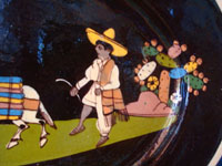 Mexican vintage pottery and ceramics, a black-ware, oval charger with exquisite and very endearing artwork, Tlaquepaque or Tonala, Jalisco, c. 1930's. Closeup photo of the wonderful Mexican campesino behind his trusty burros.