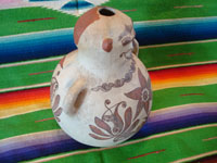 Mexican vintage folk art, and Mexican vintage pottery and ceramics, a pottery figure of a seated person, with wonderful hand-painted decorations in the style of the state of Guerrero, Tulimon, Guerrero, c. 1970. Another side view of the Guerrero figure.