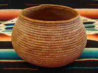 J-2: Native American Indian basket, Mission bowl with rattlesnake, c. 1920. Sumac with natural gold juncus in the rattlesnake design, which begins with the tail and rattles on the bottom of the basket and winds to the head of the rattlesnake on the side of the basket. 4" tall x 7" wide at middle x 4 3/4" diameter at mouth. Price: $2750.