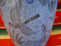 A closeup photo of decorations on one side of the Tonala burnished vase.