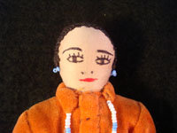 Closeup photo of the face of the second of the pair of Navajo folk art dolls.