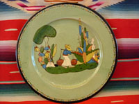 I-12: Mexican vintage pottery and ceramics, a Tlaquepaque plate with pale green background and wonderful hand-painted artwork and a beautiful squiggle pattern around the outer edge, c. 1930.