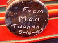 A photo showing the bottom of the Mexican vintage pottery tourist jar with signature.